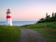 A picture of a lighthouse on the New Brunswick coast during a sunset.