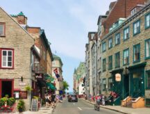 A street in Quebec with stone buildings on either side.